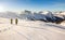 Two snowshoe hikers at sunset in alpine winter mountains. Bavaria, Germany.