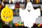 Two soaring merry halloween ghosts, hanging in the air, levitating against a blurred background