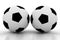 Two soccer balls on white