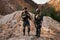 two soldiers stand on mountains talking having rest after military operation