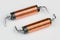 Two solenoids with helical copper wire wound on black coil on white background