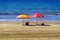 two solitary umbrellas on the beach of Maspalomas area dorada in the canary islands. Spain. Europe