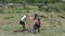 Two South African schoolgirls rinse off their used plates after lunch