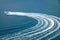 Two speedboat runs fast in the open sea and leaves the engine`s wake in the water