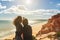 Two sports girls, on a rocky shore, take a selfie photo, successful businessmen sorts Atlantic Ocean Portugal, Falesia