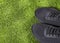 Two sports shoes on synthetic grass - Text space