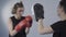 Two sports women training taekwondo punches in training gloves, use punching mitt to sharpen ones technique. Coach mitts