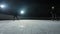 Two sportsmen hockey players who are sliding on ice arena and dribbles, hitting puck with stick. Young guys in uniforms