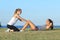 Two sportswomen doing crunches