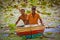 Two Sri Lankan fishermen in a lotus pond