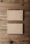 Two stack of blank craft business cards on wooden background Vertical