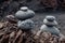 Two stacks of balanced pebbles or cairns on the beach in El Golfo, Lanzarote, Spain