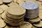 Two stacks of coins of yellow and white metal