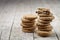 Two stacks of fresh baked oat cookies on rustic wooden table background