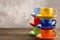 Two stacks multicolored cups on table from right side