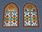 Two stained glass windows in the middle of a blue tiles in Aqsunqur mosque in Cairo