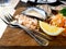 Two stainless steel fork with lime sliced, vegetable, salt and new Zealand oysters blurred background on wooden tray at restaurant