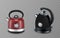 Two stainless steel red and black stovetop kettle, on transparent background.