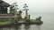 Two statues of dieties and a large statue of frog ulun danu beratan temple, bal