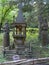 Two statues of elders cut from a tree near the wooden carved tower with a squirrel from the fairy tale `About Tsar