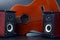 Two stereo audio speakers and classical acoustic guitar