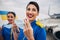 Two stewardesses holding face coverings in their hands