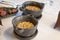 Two stone bowls with fresh and yellow wheat grain