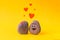 Two stones with drawn funny faces in love