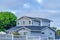 Two storey gray house with fence in San Diego California residential landscape