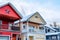 Two storey homes with balconies snowy gable roofs and garages at the facade