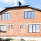 Two-storey house made of red brick. Metal-plastic windows. Newly