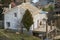 Two-storied cottage under construction. Walls of hollow foam insulation blocksand with window openings,roof beams frame and high