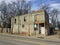 Two story abandoned business front view angled