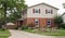 Two Story Brick & Siding House with American Flags