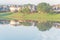 Two-story bungalow houses reflection on idyllic lake at suburban neighborhood near Dallas, Texas, USA