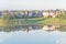 Two-story bungalow houses reflection on idyllic lake at suburban neighborhood near Dallas, Texas, USA