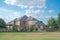 Two story suburban residential house with solar panel rooftop near rolling park side grassy lawn in Flower Mound, Texas, America