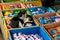 Two stray kitten cates sleeping in a crate of cleaning products and detergents, Nyaung shwe market