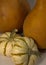 Two striped mini pumpkins with orange gourds