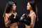 two strong and confident brunette women engaged in boxing