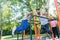 Two strong young men doing dips exercise for the upper body outdoors