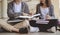 Two students are sitting on the floor reading books to education. Study for test preparation in University.