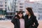 Two stylish and beautiful young girls friends wearing casual stroll around the city and smile