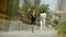 Two stylish cute women in beautiful business suits are walking around the city and talking to each other.