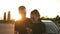 Two stylish friends or couple in black T shirts standing on a parking zone and having fun together while listening to