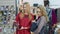 Two stylish lady in a shop of accessories and clothes are choosing handbags. successful Shopping