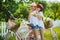 Two stylish teenage girlfriends on bicycle. Best friends enjoying day on bike