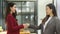 Two successful businesswomen shaking hands in the office, business dealing, greeting