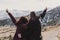 Two successful hiker woman friends enjoy the view on mountain peak at sunset. happy women in nature