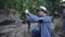 Two successful winemakers gathering harvest of grapes together in vineyard in autumn